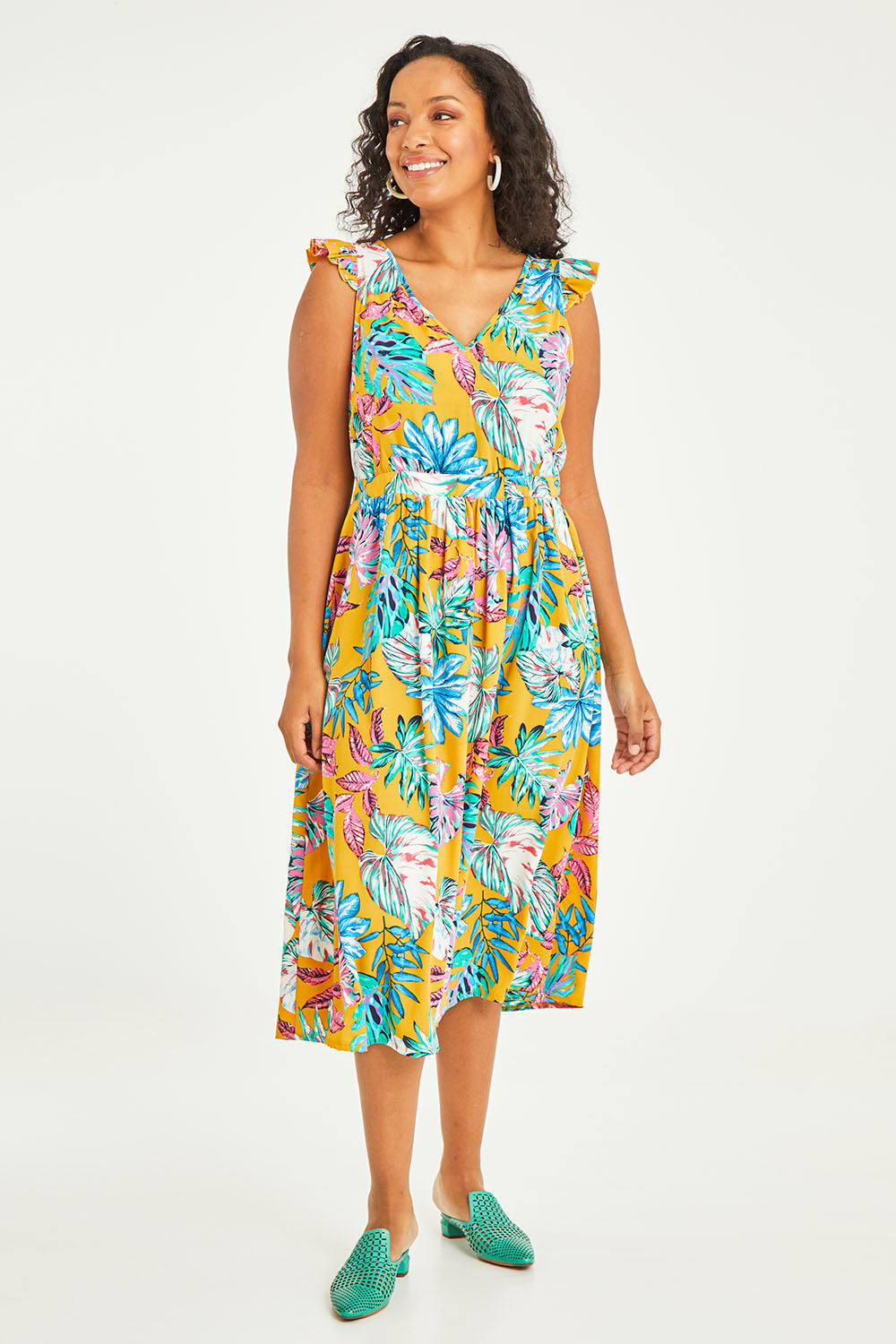 Model Noli wearing size 14 of the V Neck Gathered Sleeve Dress in colour Garden, from the front, showing the whole outfit