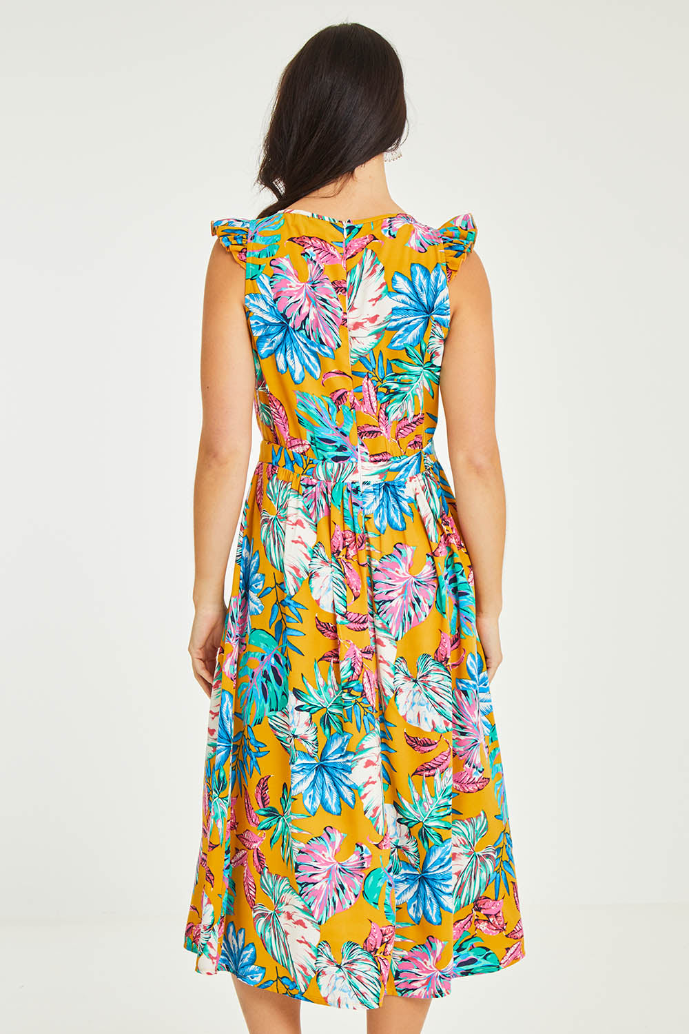 Model Stacey wearing size 10 of the V Neck Gathered Sleeve Dress in colour Garden, from the back