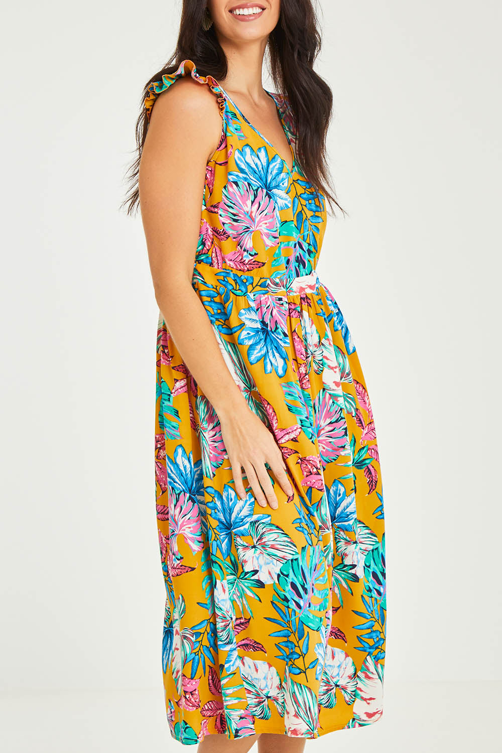 Model Stacey wearing size 10 of the V Neck Gathered Sleeve Dress in colour Garden, from the front, cropped image