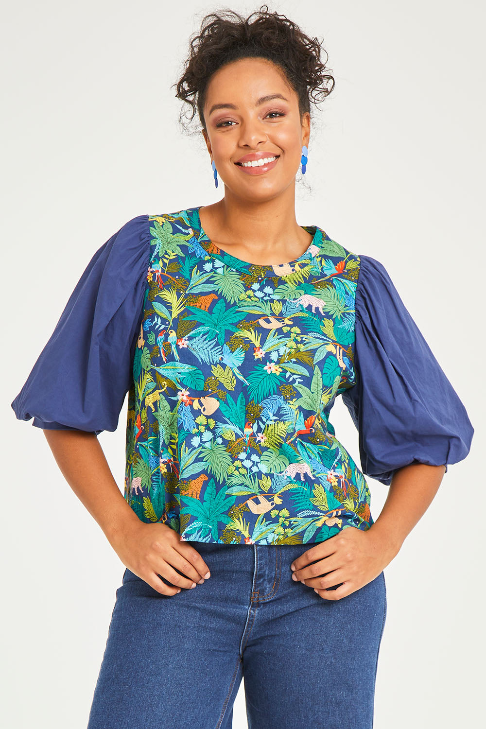 Model Noli wearing size 14 of the Printed Full Sleeve Top in colour Jungle (Blue), from the front, cropped image