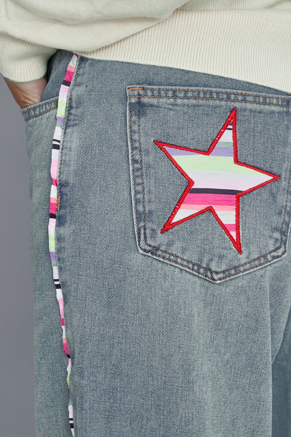 Model Alice wearing size 10 of the Patch Denim High Waisted Jeans in colour Denim (Blue), from the front, cropped image