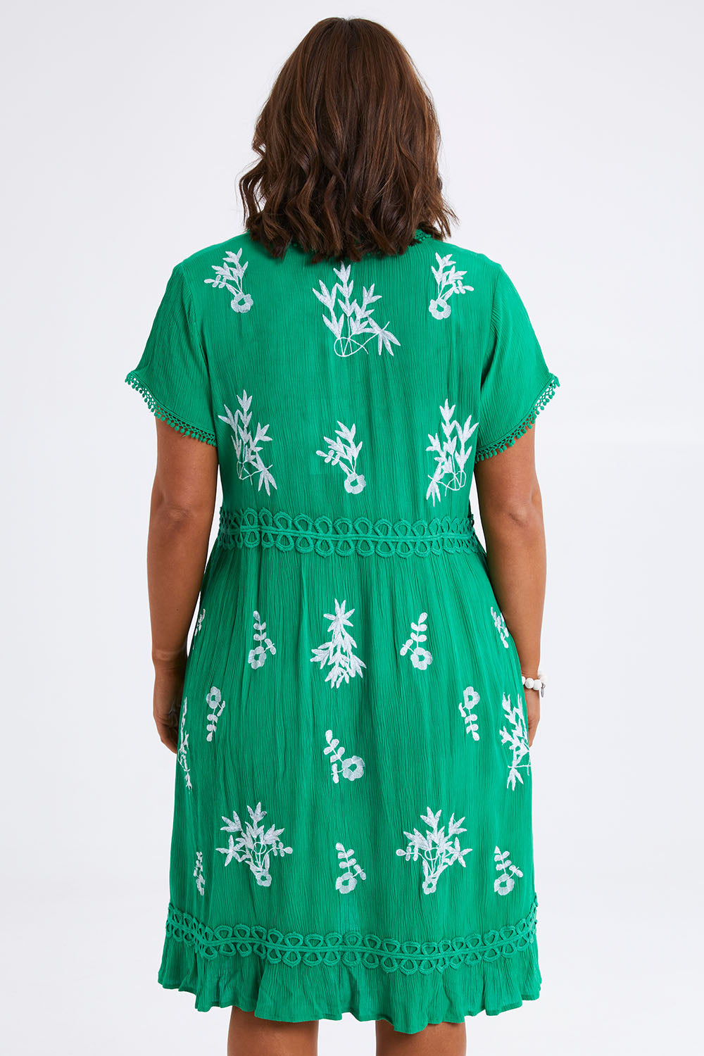 Model Monique wearing size 14 of the Embroidered Lace Detail Dress in colour Greenwhite (Green), from the back