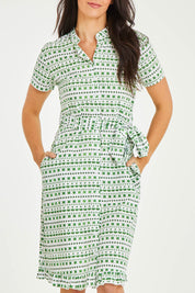 Model Stacey wearing size 10 of the Lizzie Dress in colour Emerald (Green), from the front, cropped image