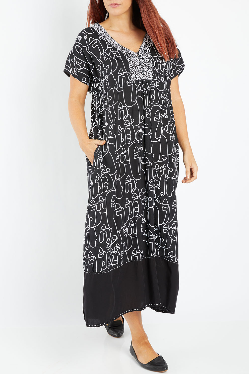 Model Laura wearing size 14 of the Evie Dress in colour Blacklinea (Black), from the front, cropped image