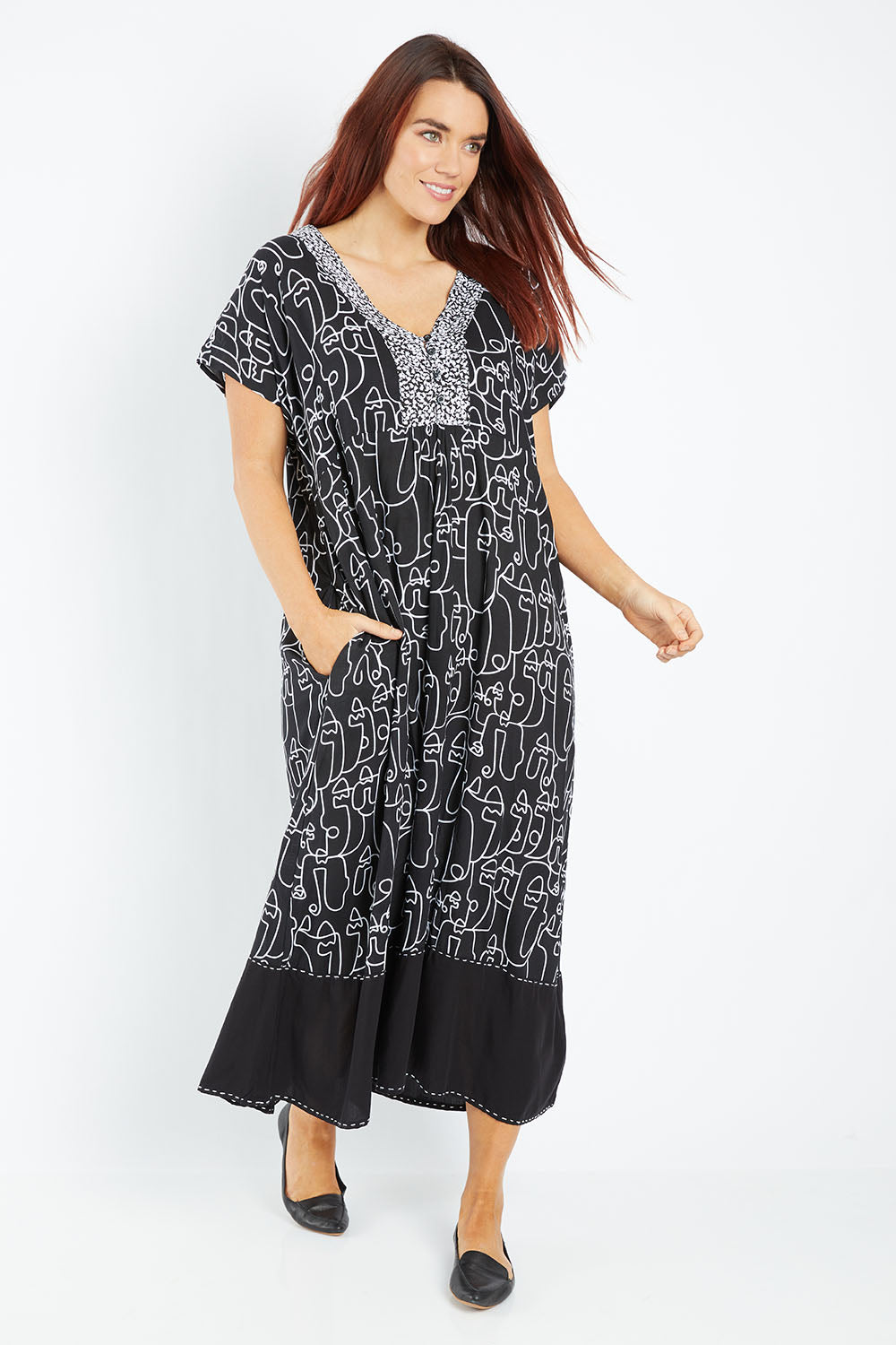 Model Laura wearing size 14 of the Evie Dress in colour Blacklinea (Black), from the front, showing the whole outfit