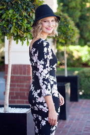 A model wearing the Kimbra Dress in colour Petal (Black), from the back