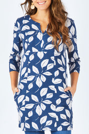Model Madeline wearing size 10 of the Classic Tunic in colour Leafnavy (Blue), from the front, cropped image