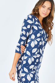 Model Madeline wearing size 10 of the Classic Tunic in colour Leafnavy (Blue), from the front, cropped image