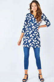Model Madeline wearing size 10 of the Classic Tunic in colour Leafnavy (Blue), from the front, showing the whole outfit