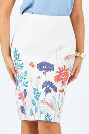 Model Abby wearing size 14 of the Border Print Fitted Skirt in colour Floralmead (White), from the front, cropped image