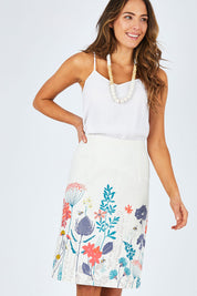Model Madeline wearing size 10 of the Border Print Fitted Skirt in colour Floralmead (White), from the front, cropped image