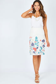 Model Madeline wearing size 10 of the Border Print Fitted Skirt in colour Floralmead (White), from the front, showing the whole outfit
