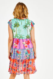 Model Naomi wearing size S of the California Tiered Dress in colour Ocean (Pink), from the back
