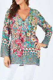 Model Abby wearing size L of the Lindeman Tunic in colour Multi (Pink), from the front, cropped image