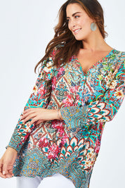 Model Abby wearing size L of the Lindeman Tunic in colour Multi (Pink), from the front, cropped image
