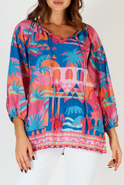 A model wearing the Rowanna Cotton Top in colour Blue (Blue), from the front, cropped image