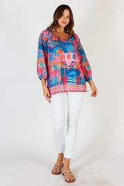 A model wearing the Rowanna Cotton Top in colour Blue (Blue), from the front, showing the whole outfit