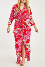 Model Katie wearing size 16 of The Printed Nadine Dress in colour Hibiscus (Red), from the front, cropped image