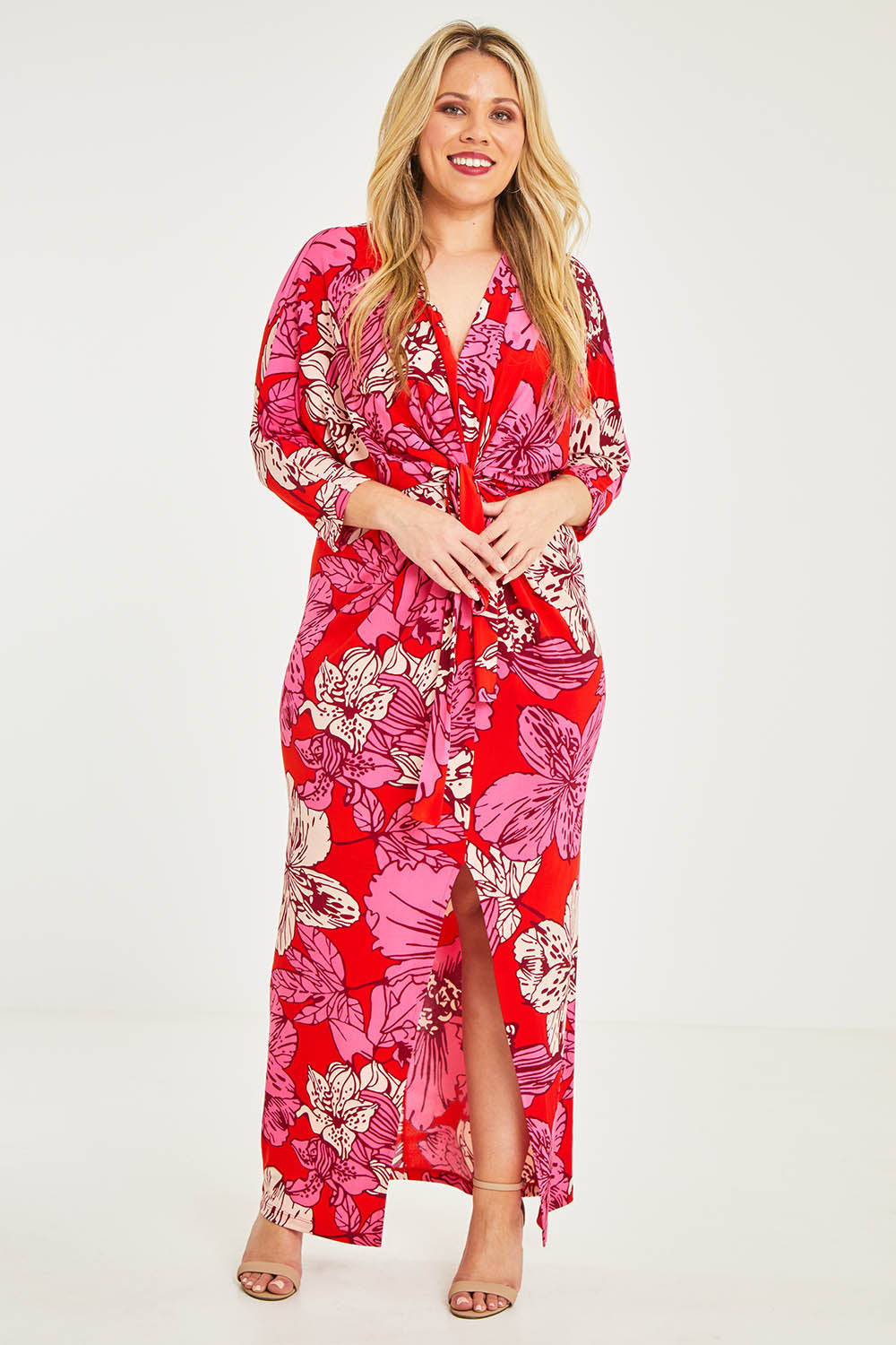 Model Katie wearing size 16 of The Printed Nadine Dress in colour Hibiscus (Red), from the front, showing the whole outfit