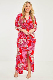 Model Katie wearing size 16 of The Printed Nadine Dress in colour Hibiscus (Red), from the front, showing the whole outfit