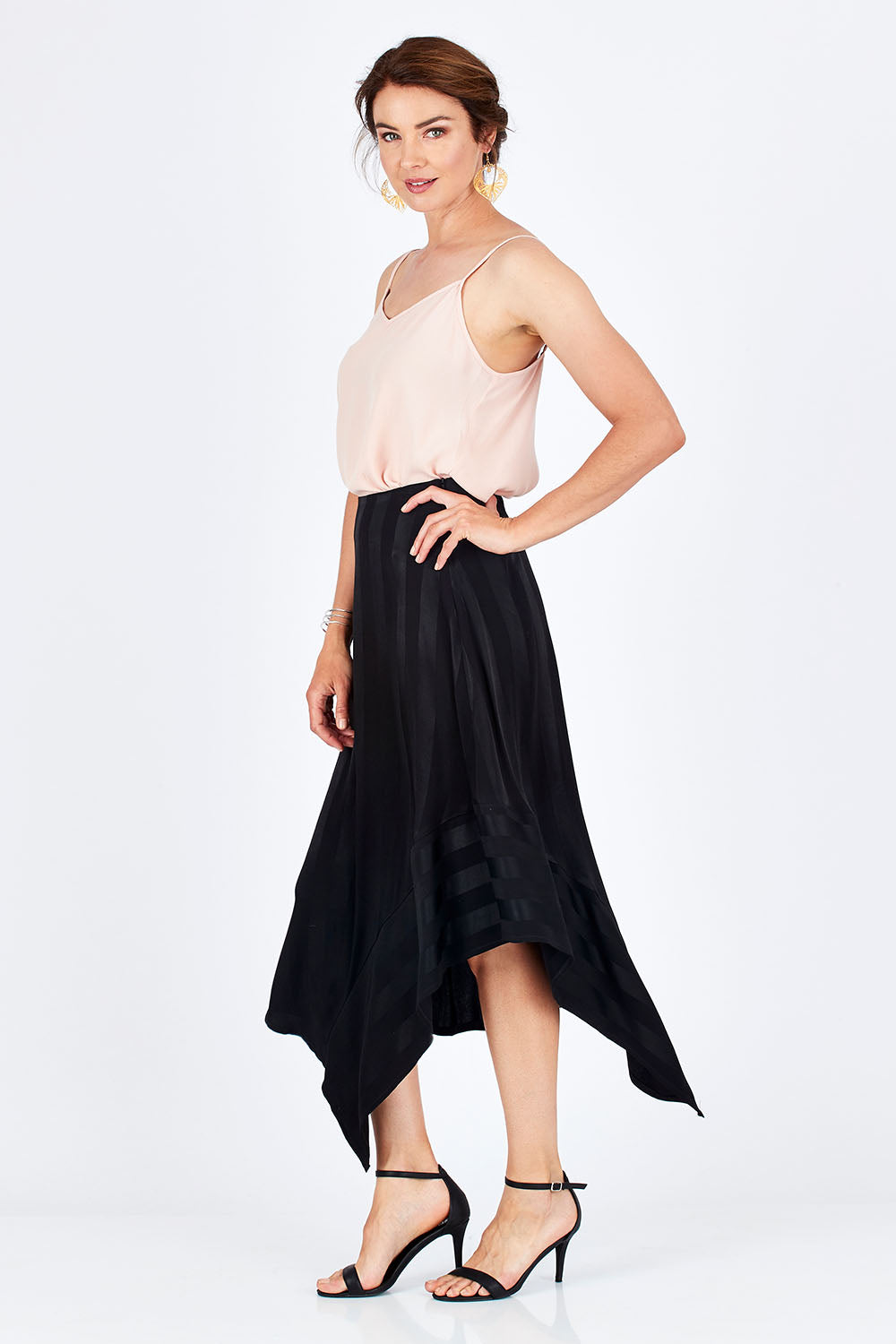 Model Rebecca wearing size 10 of the Yen Skirt in colour Black (Black), from the front, showing the whole outfit
