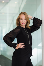 Model Katie wearing size 10 of the Sharyn Blouse in colour Black (Black), from the front, showing the whole outfit