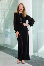 Model Katie wearing size 10 of the Sharyn Blouse in colour Black (Black), from the front, showing the whole outfit