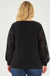 Model Katie wearing size 16 of the Sharyn Blouse in colour Black (Black), from the back