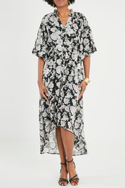 Model Aiyana wearing size 10 of the Natasha Dress in colour Floral (Black), from the front, cropped image