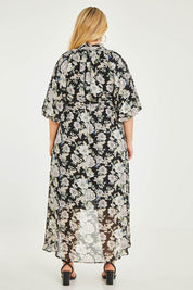Model Katie wearing size 16 of the Natasha Dress in colour Floral (Black), from the back