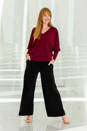 Model Katie wearing size 10 of the Kristi Pants in colour Black (Black), from the front, showing the whole outfit