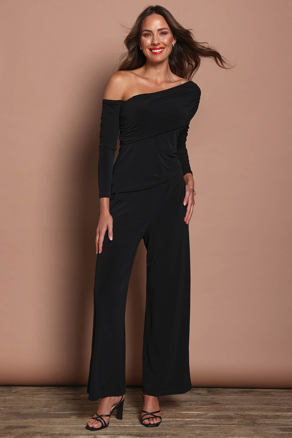 Model Madeline wearing size 10 of the Kristi Pants in colour Black (Black), from the front, showing the whole outfit