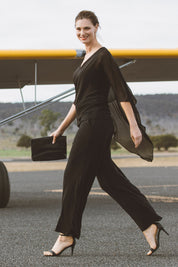 Model Anneliese wearing size 10 of the Marie Top in colour Black (Black), from the front, showing the whole outfit