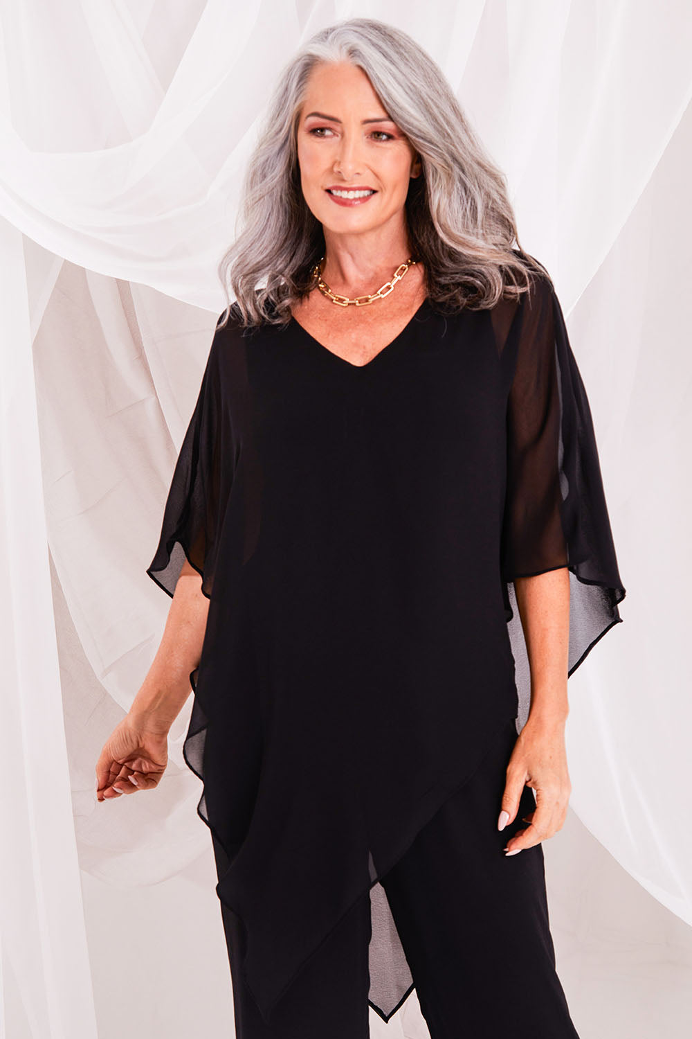 Model Luisa wearing size 10 of the Marie Top in colour Black (Black), from the front, showing the whole outfit