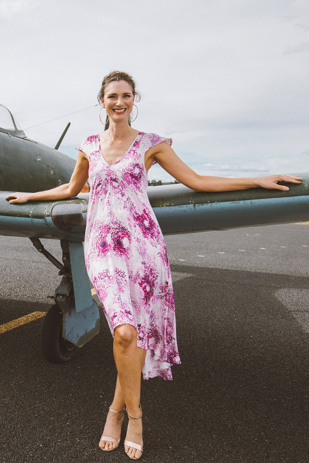Model Anneliese wearing size 10 of the Prue Dress in colour Jacaranda (Pink), from the front, showing the whole outfit