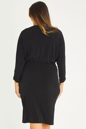 Model Palatina wearing size 16 of the Nancy Dress in colour Black (Black), from the back