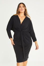 Model Palatina wearing size 16 of the Nancy Dress in colour Black (Black), from the front, cropped image