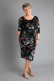 A model wearing size 8 of the Janelle Dress in colour Moonstone (Black), from the front, showing the whole outfit