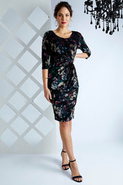 Model Madeline wearing size 10 of the Janelle Dress in colour Moonstone (Black), from the front, showing the whole outfit