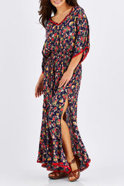 Model Chesska wearing size M of the Flamingo Dress Roza Print in colour Navy (Blue), from the front, cropped image