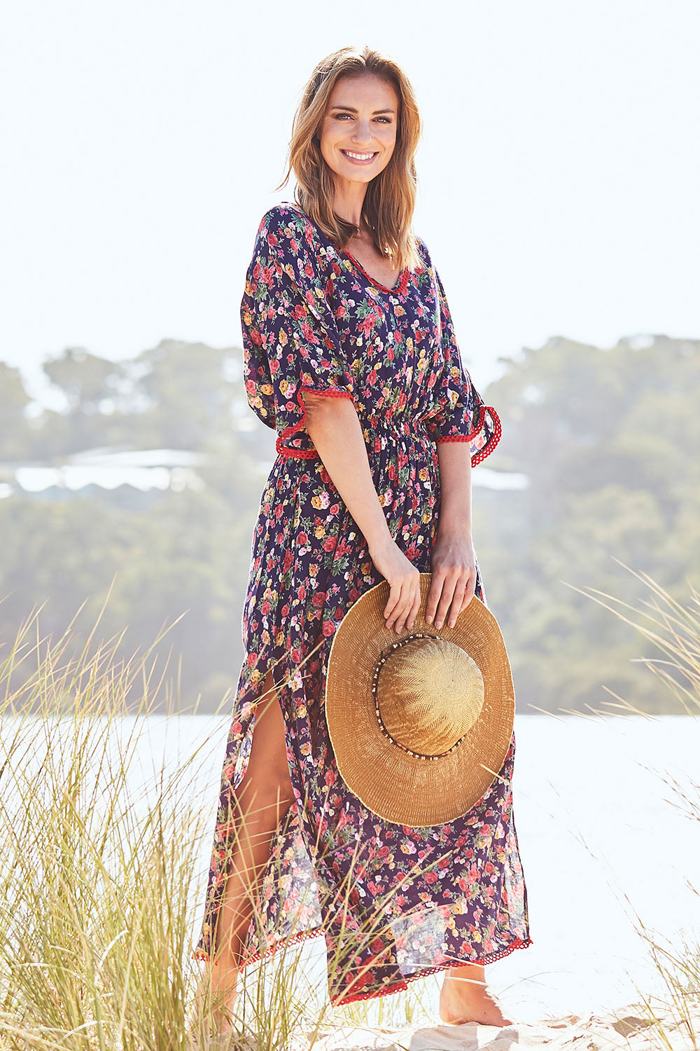 Model Riina wearing size S of the Flamingo Dress Roza Print in colour Navy (Blue), from the front, showing the whole outfit