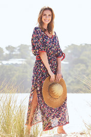 Model Riina wearing size S of the Flamingo Dress Roza Print in colour Navy (Blue), from the front, showing the whole outfit