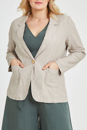 Model Keeara wearing size 16 of the Cotton Linen Longline Blazer in colour Desertsand, from the front, cropped image
