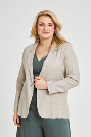 Model Keeara wearing size 16 of the Cotton Linen Longline Blazer in colour Desertsand, from the front, cropped image