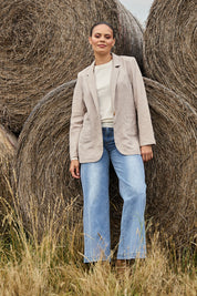Model Lala wearing size 10 of the Cotton Linen Longline Blazer in colour Desertsand, from the front, showing the whole outfit