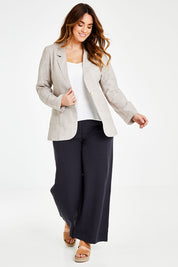 Model Laura wearing size 14 of the Cotton Linen Longline Blazer in colour Desertsand, from the front, showing the whole outfit