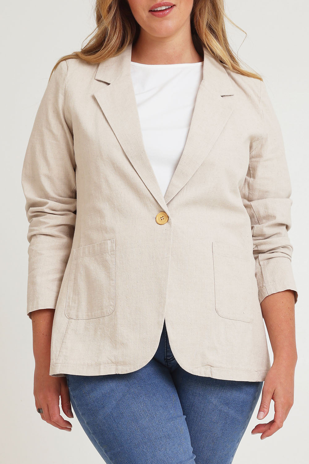 Model Chanel wearing size 16 of the Cotton Linen Longline Blazer in colour Sand, from the front, cropped image