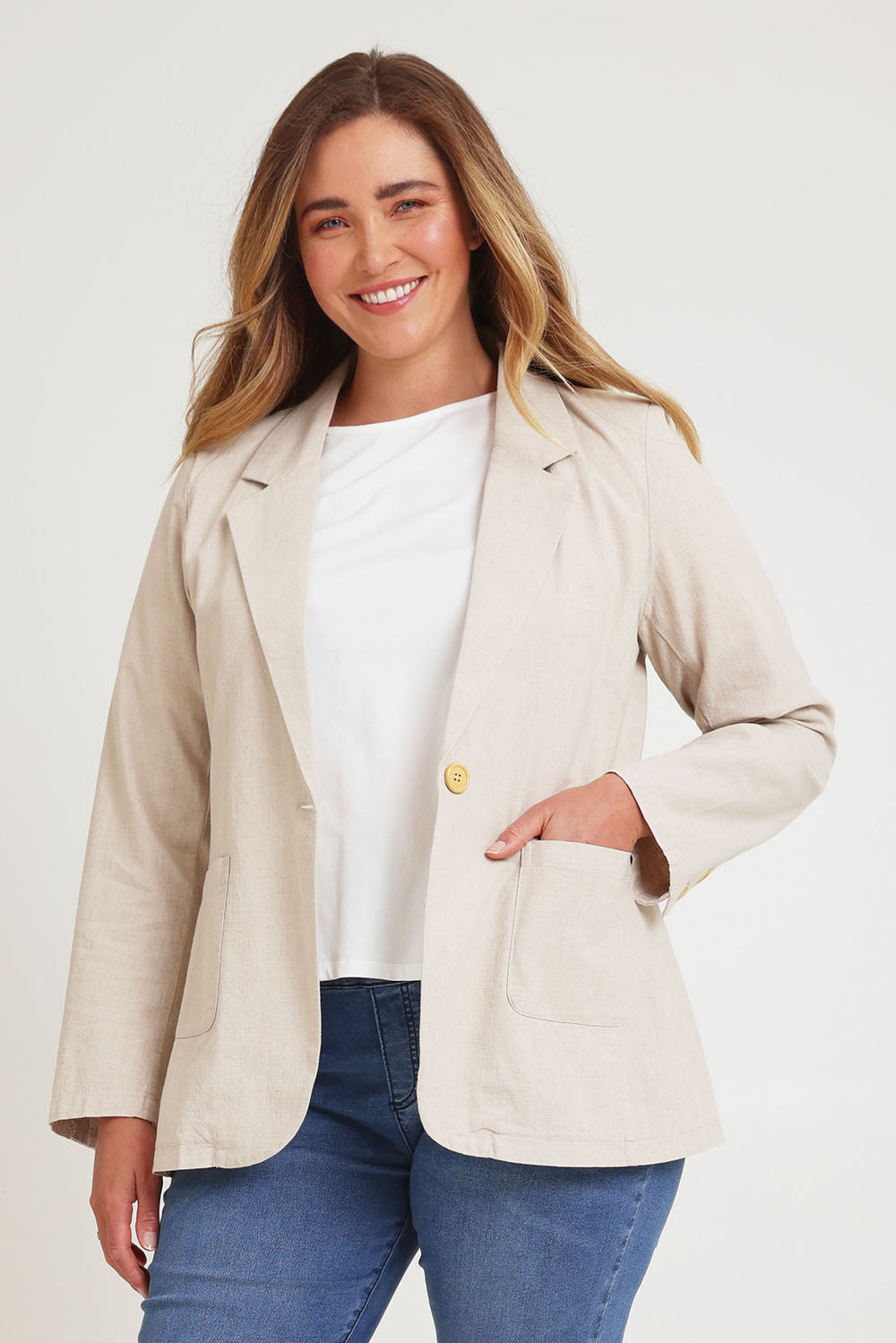 Model Chanel wearing size 16 of the Cotton Linen Longline Blazer in colour Sand, from the front, cropped image