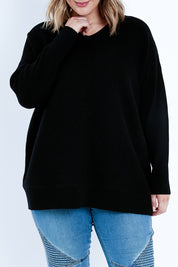 Model Jess wearing size L of the Wool Cashmere Relaxed V Neck Jumper in colour Black (Black), from the front, cropped image