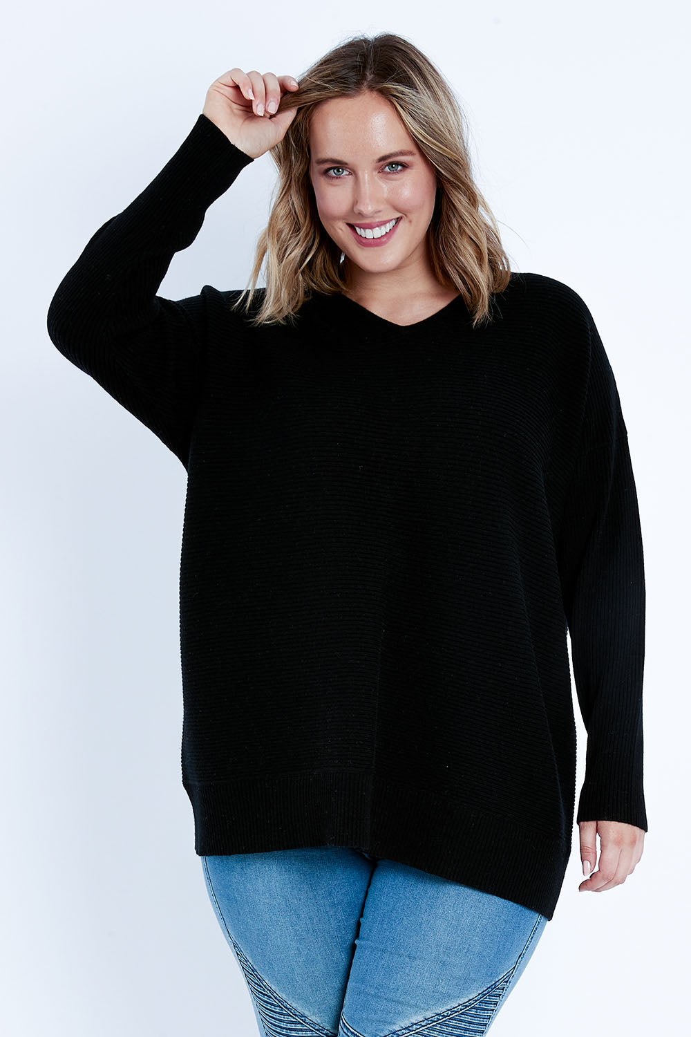Model Jess wearing size L of the Wool Cashmere Relaxed V Neck Jumper in colour Black (Black), from the front, cropped image